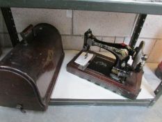 A cased manual sewing machine,