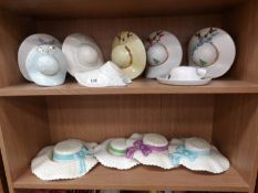 12 assorted ceramic hat wall pockets, (2 shelves).