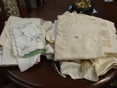 A good collection of vintage linen and lace including silk and lace underwear, wedding ensembles.