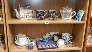 2 shelves of tea related collectables including moustache cup & saucer,