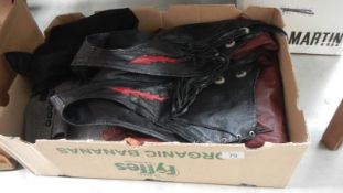 A box of vintage clothing including leather.