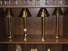 4 brass candle lamps.