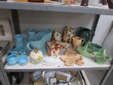 A shelf of assorted pottery including Wade, Sylvac etc.