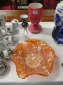 A large carnival glass bowl and 2 other glass items.