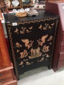 A Japanese style lacquered cabinet.
