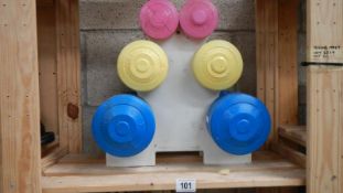 3 pairs of exercise weights on stand.