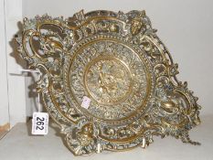 A heavy ornate brass dish.