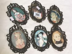 5 oval metal frames with pictures.