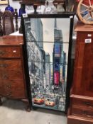 A tall 5 drawer chest with pictorial front of New York Madison Avenue.