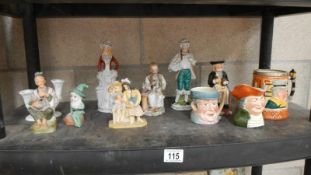 A shelf of figures, Toby jugs etc.