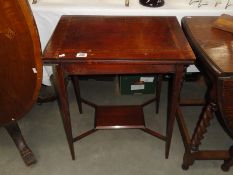 An Edwardian mahogany inlaid fold over card table.