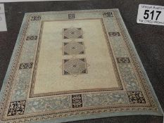 A good quality beige rug, 230 x 170 cm.