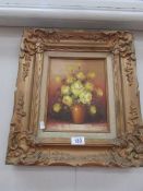 A floral rose study in gilt frame, signed but indistinct.