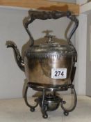 A silver plate spirit kettle on stand.
