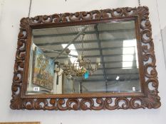 An oak framed bevel edged mirror.