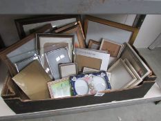 A box of assorted photo frames.