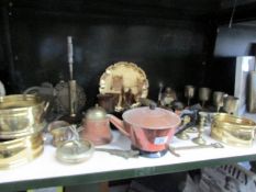 A shelf of assorted brass and copper.