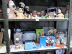 2 shelves of Wallace and Gromit collectables including clocks, soft toys, figures etc.