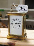 A brass carriage clock.