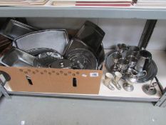 A shelf of assorted silver plate etc.