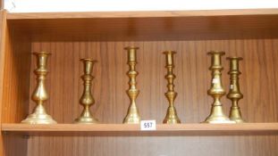 3 pairs of brass candlesticks.