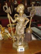 A brass companion set in the form of a Scotsman.