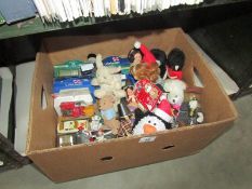 A box of toys including dolls, die cast vehicles etc.