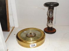 A ships barometer and an hour glass.