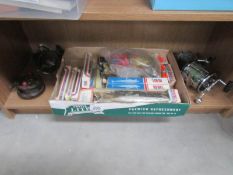 A mixed lot of angling items including reels etc.