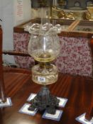 A Victorian oil lamp with etched glass shade.