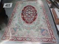 A red patterned rug, 179 x 121 cm.