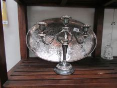 An oval silver plated tray and a candelabra.