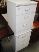 A pair of white 3 drawer bedside chests.