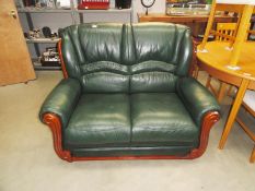 A two seater green leather sofa