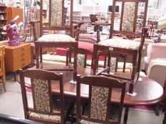 A dark oak extending dining table with 4 chairs and 2 carver chairs in Jacobean style
