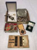 A mixed lot including jewellery, corkscrews,