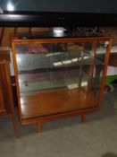 A 3 shelf glazed cabinet