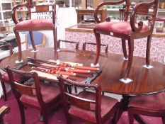 A contemporary mahogany extending dining table and 6 brass inlaid chairs including 2 carvers in the