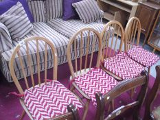 A set of 4 light oak ERCOL hoopback chairs