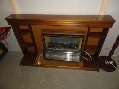 A fire surround with electric fire