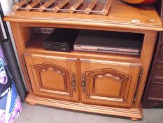 A heavy light oak sideboard with drawers and contents including DVD player,