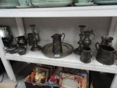 A collection of pewter and metalware including candlesticks