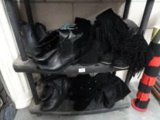 Two shelves of black boots and shoes