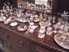 A large quantity of silver plate egg cups