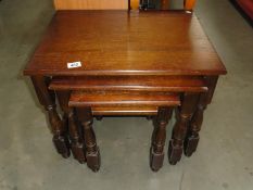 A nest of 3 oak tables