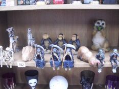 A shelf of animal figures and various See No / Hear No / Speak No Evil Halloween related figures