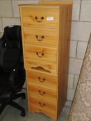 A pair of pine effect bedside chest of drawers