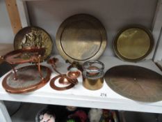 A shelf of brass and copperware including sundial etc