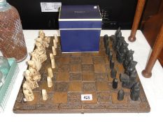 A chess set with wooden chess board (missing 1 white rook)