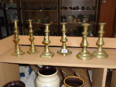 3 pairs of brass candlesticks